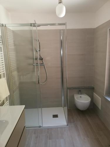a bathroom with a shower with a toilet and a sink at Al Drit in Verrès