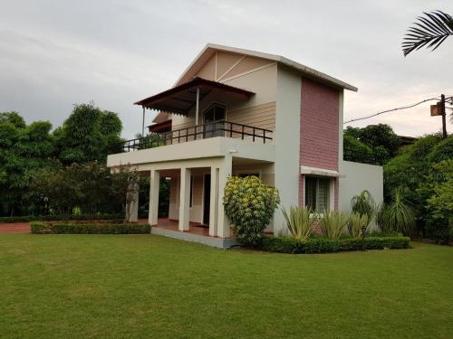 a house with a lawn in front of it at Celestial Resorts, Retreat in Nature in Phanda