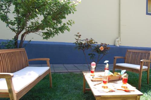 a table and two chairs and a table with food on it at Albicocche House in Giarre