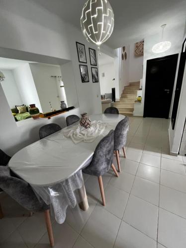 a dining room with a white table and chairs at La Vida Villa Alcudia Smir Fnideq, Holiday Homes in Tetouan