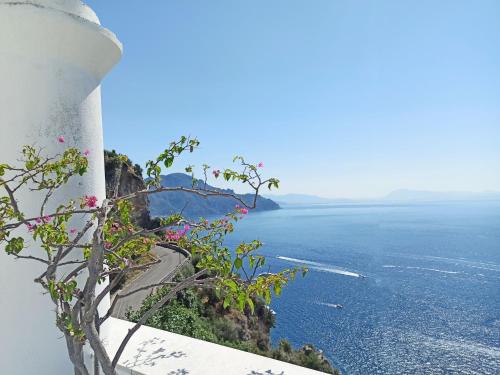 a view of the ocean from the side of a lighthouse at Emerald's Resort - Filomena in Conca dei Marini