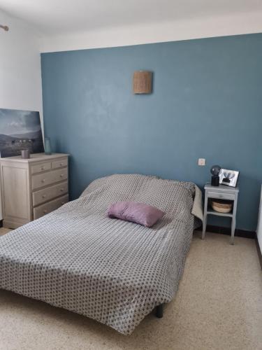 a bedroom with a bed with a purple pillow on it at Maison Gemenos in Gémenos