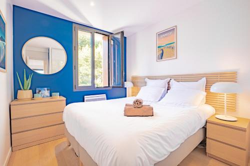 - une chambre avec un grand lit blanc et des murs bleus dans l'établissement SUNRISE LOVER by K6Conciergerie, à Cassis