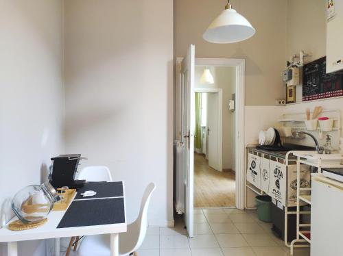 a kitchen with a table and chairs in a room at Appartamento La Rampa in Benevento