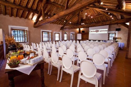 a room with rows of tables and chairs in a building at Agriturismo Cascina Caremma in Besate