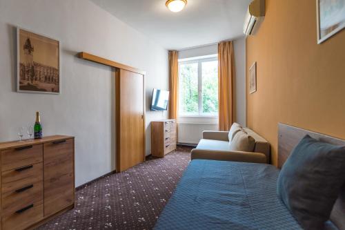 a living room with a couch and a window at Hotel Museum in Prague