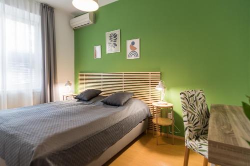 a bedroom with a bed and a green wall at Hotel Museum in Prague