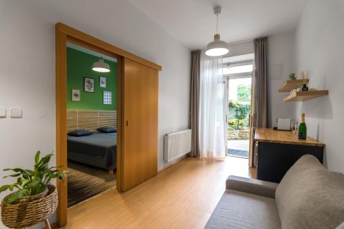 a living room with a couch and a bedroom at Hotel Museum in Prague