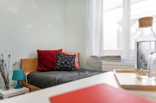 a living room with a couch and a window at Penzion Village Peace #29 by Goodnite cz - U Libušky in Brno