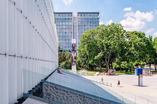 a person sitting on a ramp next to a building at AURUM PREMIUM SPA UNIA RESIDENCE in Lublin
