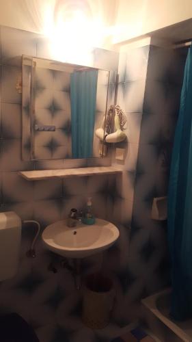 a bathroom with a sink and a mirror at Rooms and Apartments Roza in Portorož