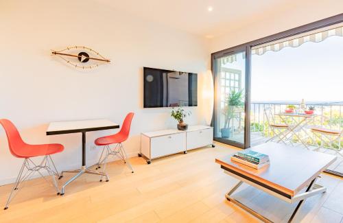 un salon avec une table et des chaises rouges dans l'établissement SUNRISE LOVER by K6Conciergerie, à Cassis