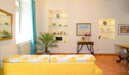 a living room with a yellow couch and a table at Luxury Apartment Federica N 1 Centro Storico di Taormina in Taormina