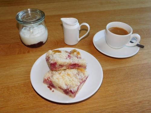 a white plate with a piece of cake and a cup of coffee at Vila Eden in Pec pod Sněžkou