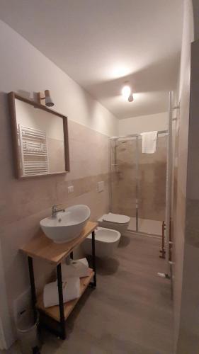a bathroom with two sinks and a shower at CA' DEL VINO Rooms- Varzo in Varzo