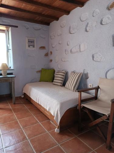 a bedroom with a bed and a wall with shells at Villa Panayiota in Alonnisos