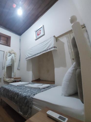 a bedroom with a bed and a mirror at Lily Town Hotel in Antalya