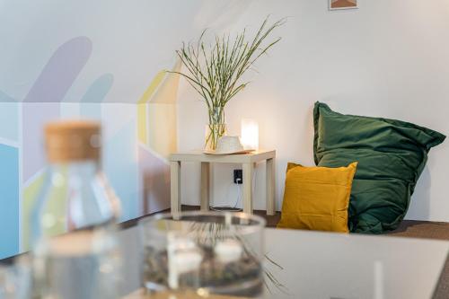 a living room with a couch and a glass table at Penzion Village Peace #29 by Goodnite cz - U Libušky in Brno