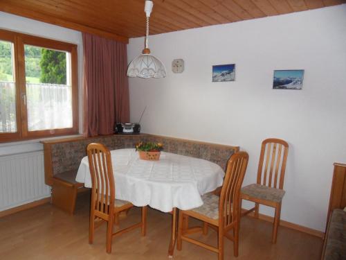 a dining room with a table and chairs at Haus Konzett in Dalaas