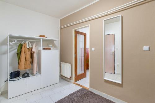 a hallway with a mirror and a walk in closet at Penzion Village Peace #29 by Goodnite cz - U Libušky in Brno