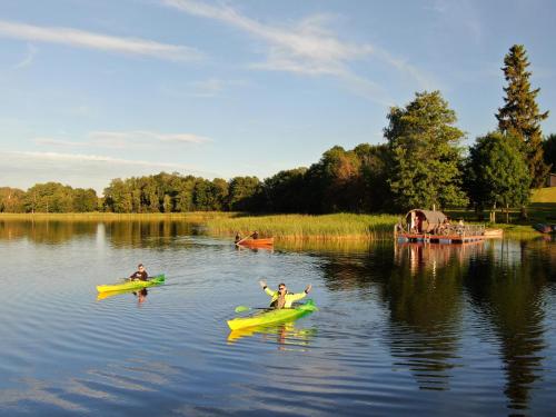 two people are kayaking on a lake at Atpūtas vieta Ežezers in Andzeļi