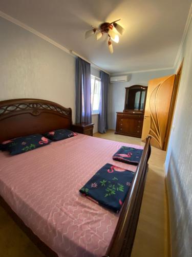 a bedroom with a bed and a ceiling fan at Apartment on Abazgaa in Gagra