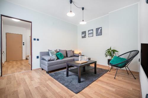 a living room with a couch and a table at Penzion Village Peace #29 by Goodnite cz - U Libušky in Brno
