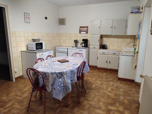 a kitchen with a table with a table cloth on it at Gîte Chez Jeannot in Azay-le-Ferron