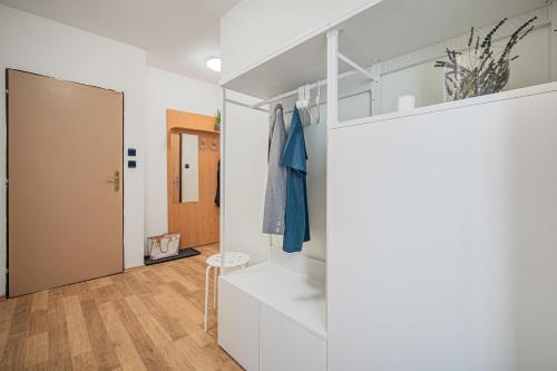 a room with white walls and a hallway with a door at Penzion Village Peace #29 by Goodnite cz - U Libušky in Brno