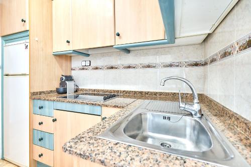 a kitchen with a sink and a counter top at Espanhouse David 2 bedroom apartment Torrevieja with pool in Torrevieja