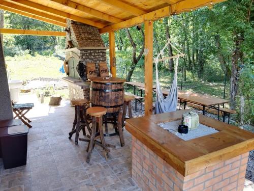 an outdoor patio with a table and a fireplace at Green House in Rijeka