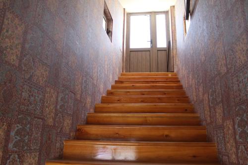 a stairway leading up to a door in a building at Mevlana Hotel in Samarkand