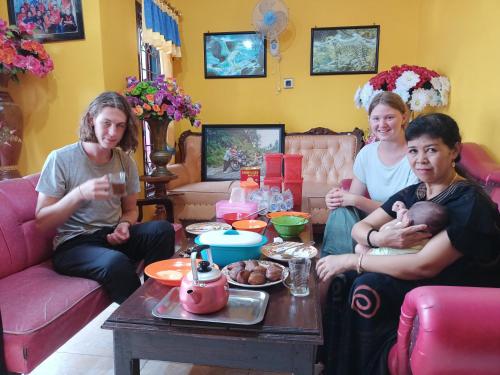 a group of people sitting around a living room at Homestay Lidiya in Banyuwangi