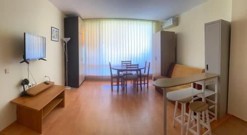 a living room with a table and a dining room at Nessebar Fort Club Apartment 226 in Sunny Beach