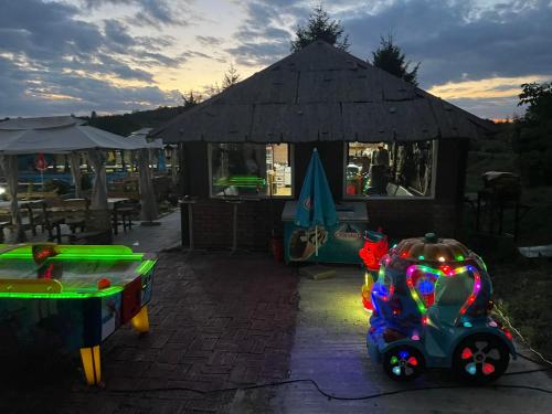 a ping pong table and a toy car on a patio at Holiday Home Rodjak sa sela in Mionica