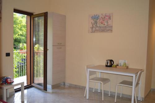 a table and chairs in a room with a balcony at Il Rivolo in Sorrento