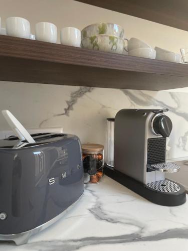 a kitchen counter with a toaster and a toaster and a toaster at Appart POP 1 Centre ville calme avec parking in Arras