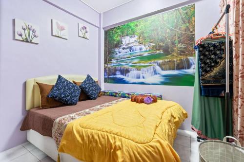 a bedroom with a bed with a painting on the wall at 2 scenic air cond bedrooms, 1 room ceiling fan, near Bandar Rawang in Rawang