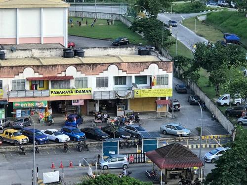a parking lot with cars parked in front of a building at 2 scenic air cond bedrooms, 1 room ceiling fan, near Bandar Rawang in Rawang