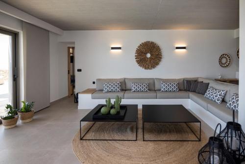 a living room with a couch and a table at Blue Gres Villa Tinos in Tinos Town