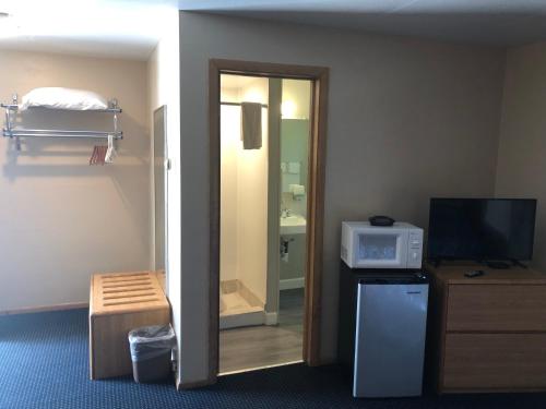 a hotel room with a television and a microwave at Parkway Motel in Neenah