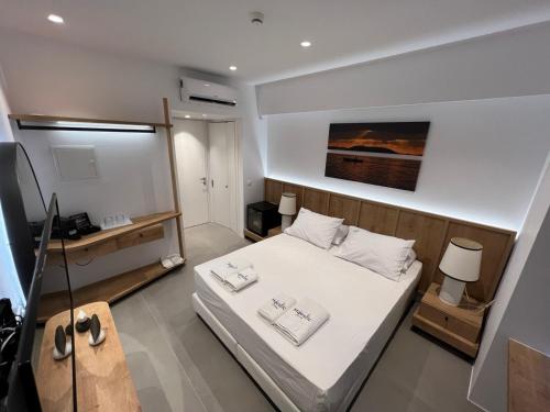a bedroom with a bed with two towels on it at Majestic Mykonos in Ornos