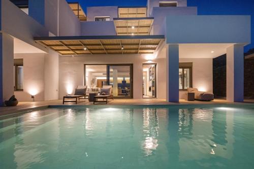 a swimming pool in a villa at night at Blue Gres Villa Tinos in Tinos Town