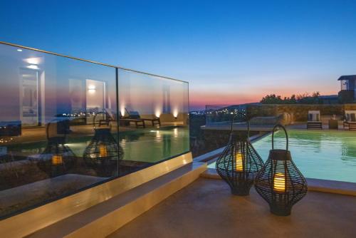 a house with a swimming pool and lights at Blue Gres Villa Tinos in Tinos Town