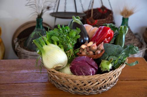 a basket of vegetables sitting on a table at Agriturismo Masseria Cannella in Lesina