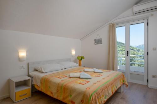 Postel nebo postele na pokoji v ubytování Apartments Mili