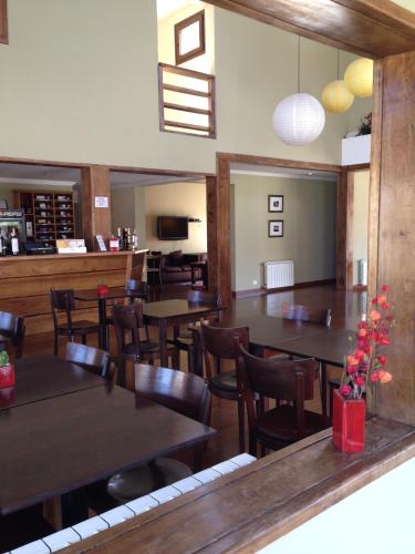 a dining room with wooden tables and chairs at Hotel Poincenot in El Chalten