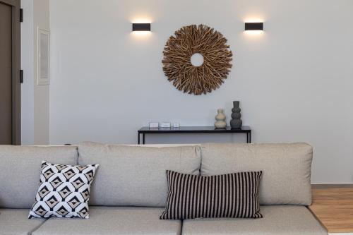 a living room with a couch and a mirror on the wall at Blue Gres Villa Tinos in Tinos Town