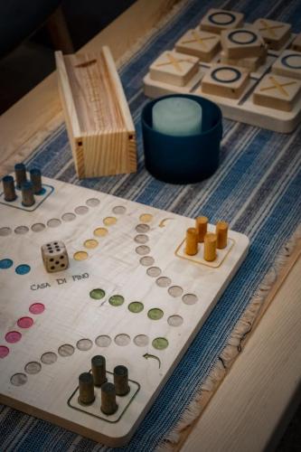 a table with a cake with a board game on it at Casa di Pino EcoLodge Hotel in Žabljak