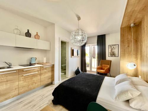 a bedroom with a large bed and a kitchen at Apartments and Rooms Mateša in Vodice